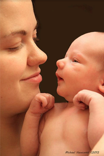 Close up portrait of a Mom and newborn